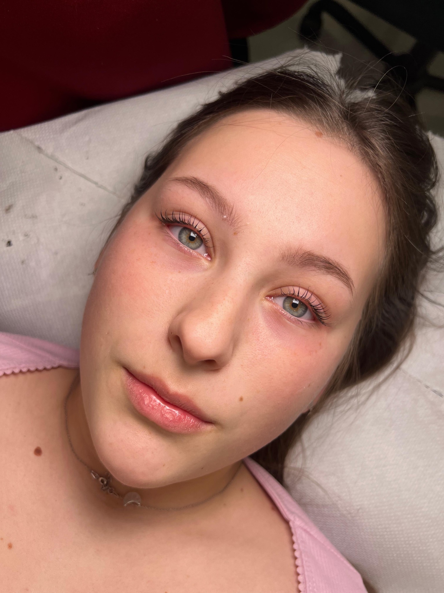 Full-face portrait showing a natural lash lamination result