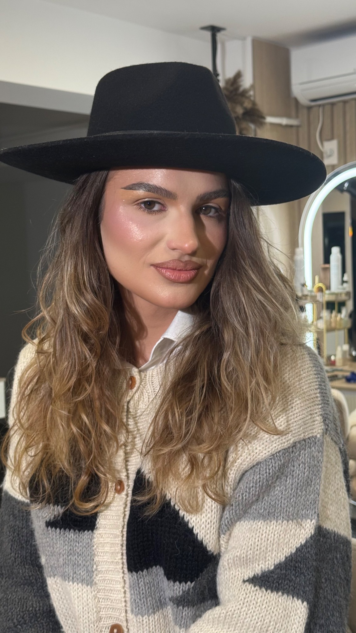 Editorial makeup portrait with black hat
