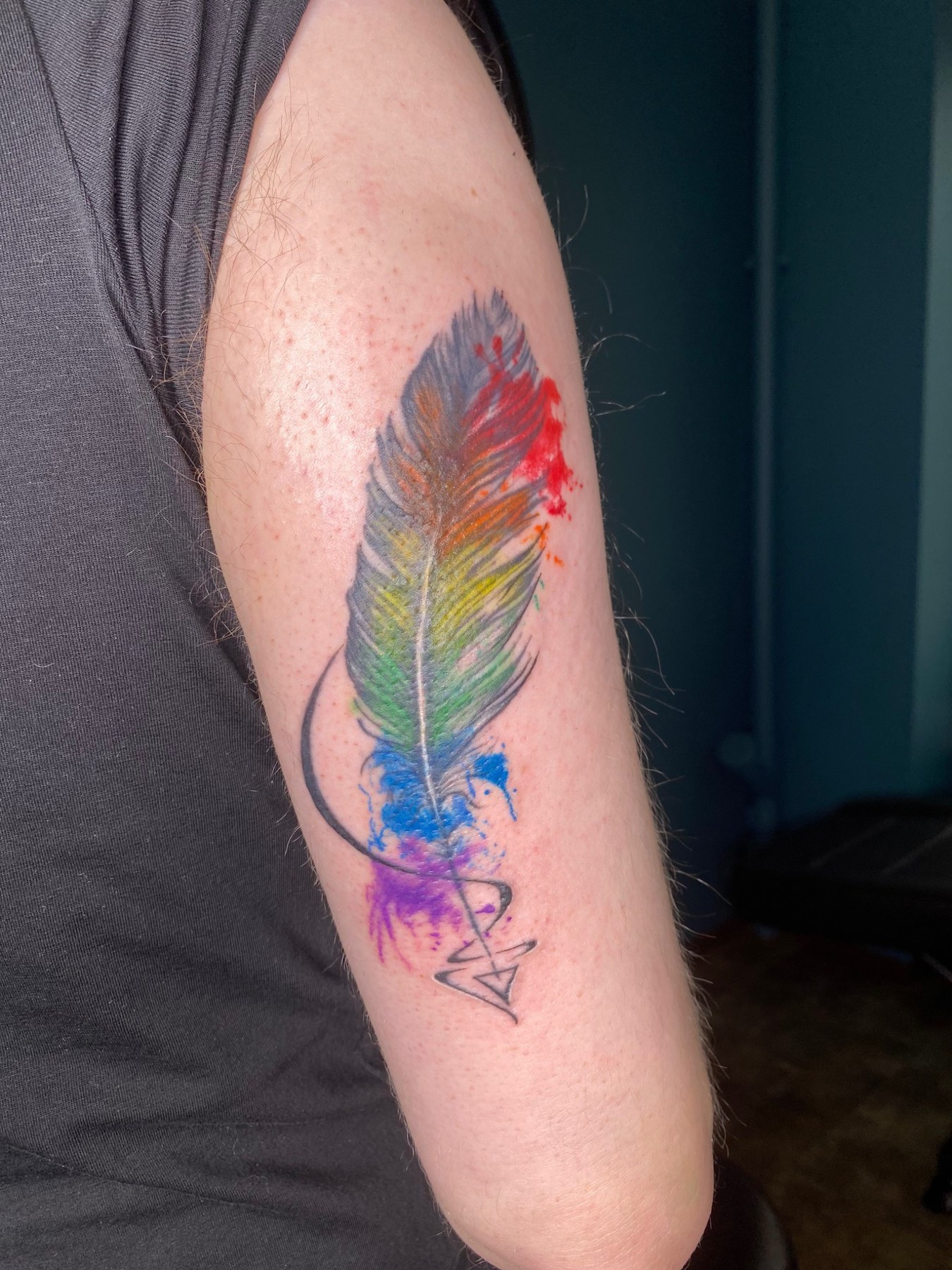 Colour feather tattoo close view