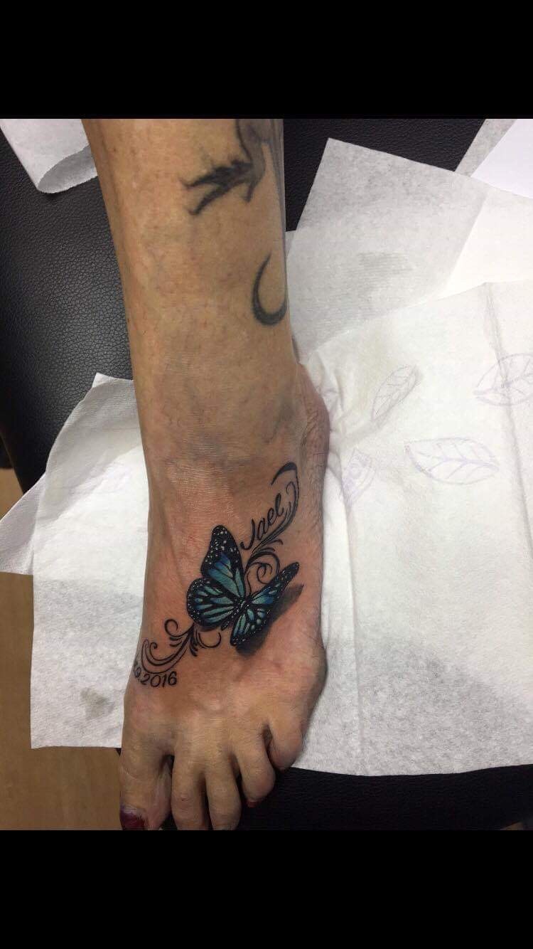Butterfly foot tattoo