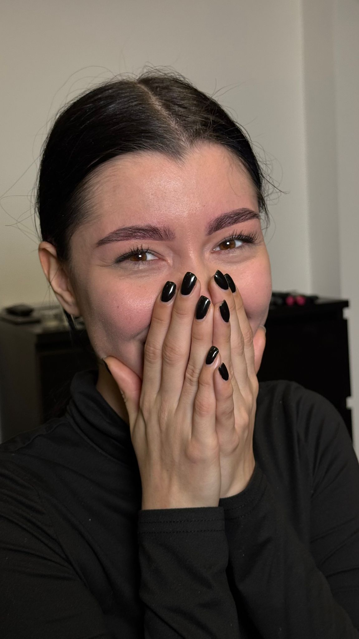 Smiling client after a Premiere Beauty brow treatment